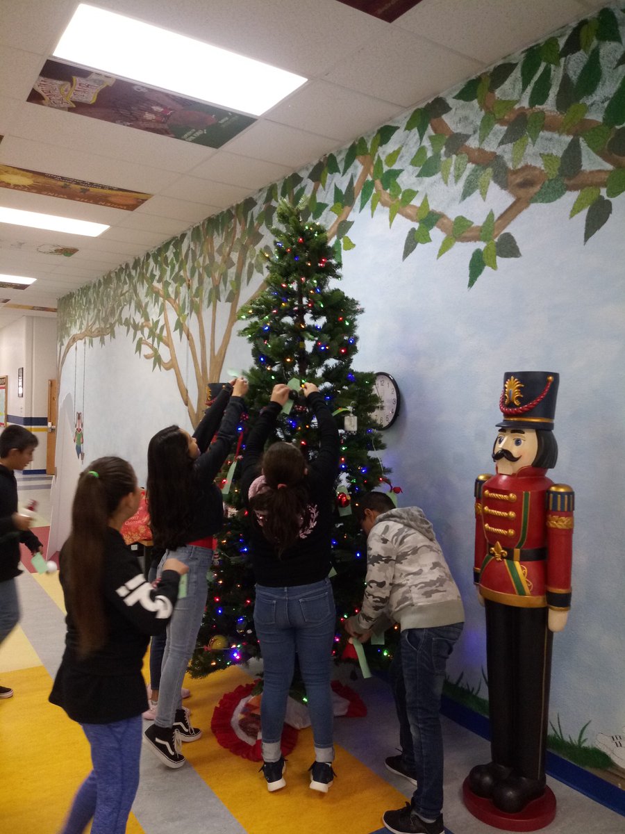 DLTeagleLibrary's tweet photo. FME students hanging their Story Book Ornaments on our Christmas tree. They all did a beautiful job! @fmeeagles #FMEpride #WeAreClintISD https://t.co/fnfBEBJ2e5