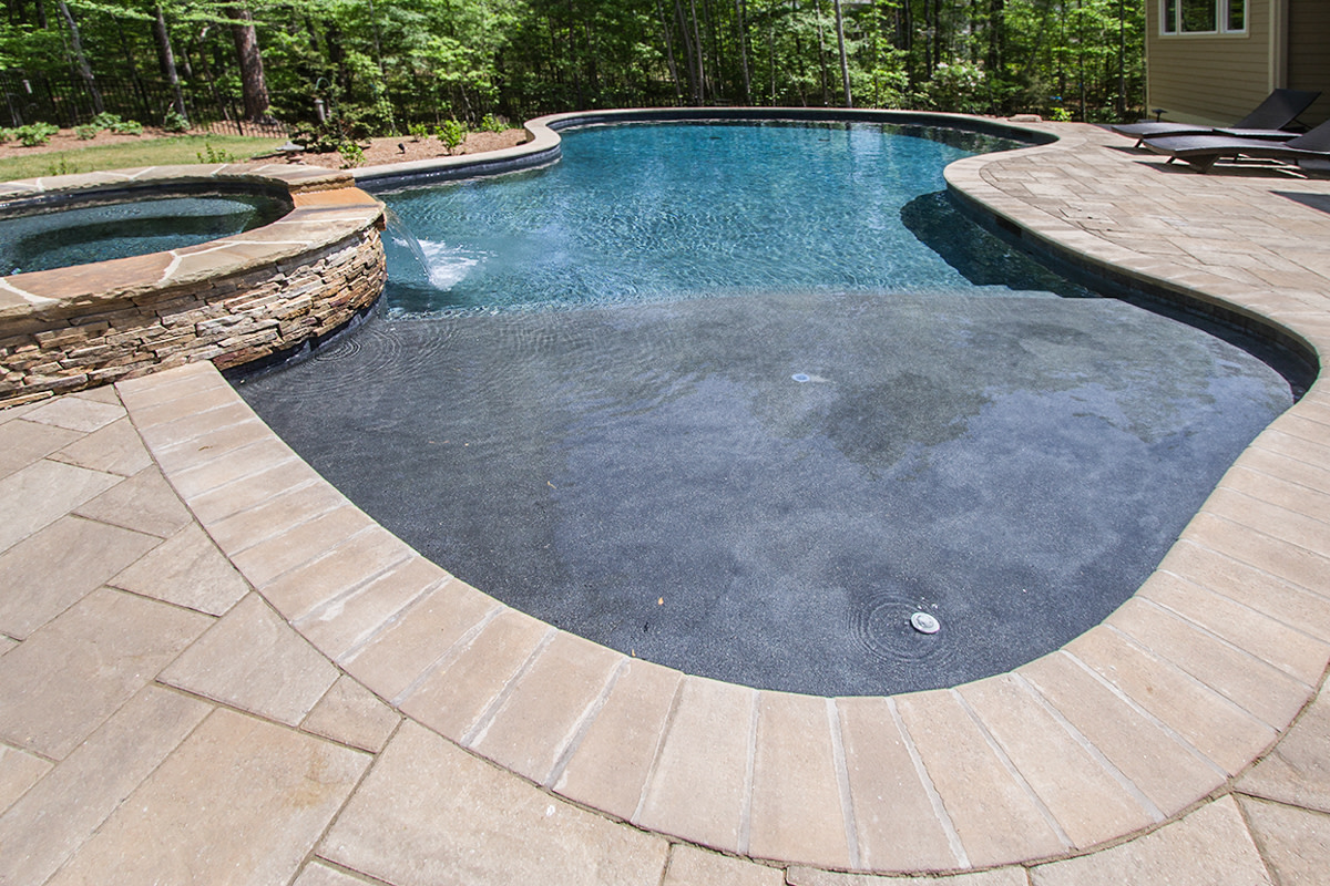 BlueHavenPoolNC's tweet image. This #freeformpool &amp;amp; attached spa take advantage of the property's naturally sloping yard by utilizing the pool as a retaining wall. In doing so, we were able to include an #outdoorkitchen and grill area in the design that helps give this property a simple yet #charming appeal.