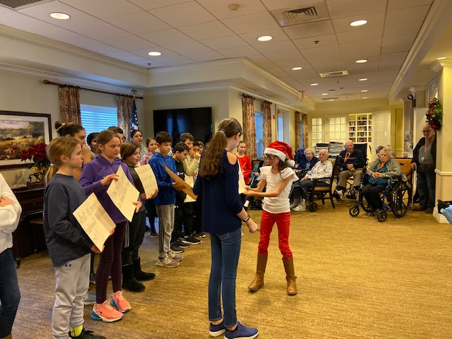 dateritc's tweet photo. Dater/Wandell 5th Grade Book Club bringing holiday cheer to Brighton Gardens in Saddle River! Giving out candy and a craft, playing trivia, and singing holiday songs under the direction of Mr. Bogert was enjoyed by all. https://t.co/dQOXH4gSUM