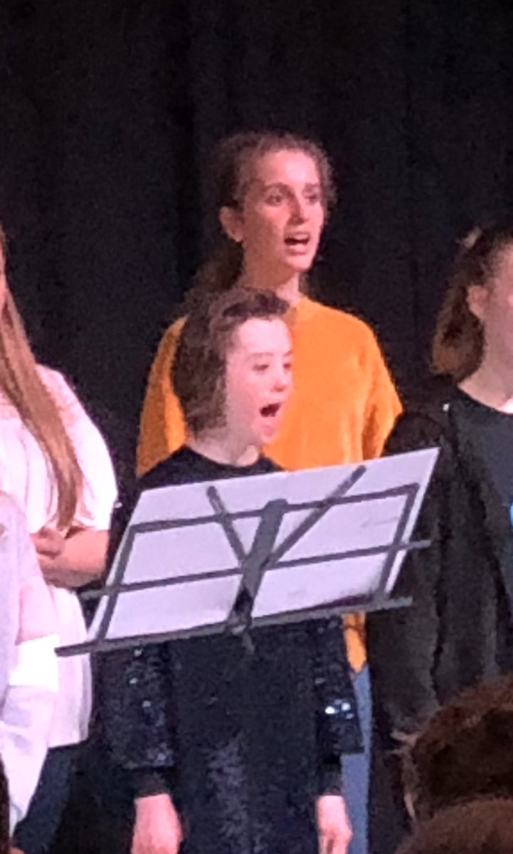 PippaCan's tweet photo. Tonight Pippa sung, alongside her sister, in the school choir at a school concert. She was front row, centre and performed with her usual enthusiasm! Everyone else was stood still singing and Pippa was singing, flossing and dancing too!!#DownSyndrome #inclusion #mainstreamschool https://t.co/ZWryJ9kZg5