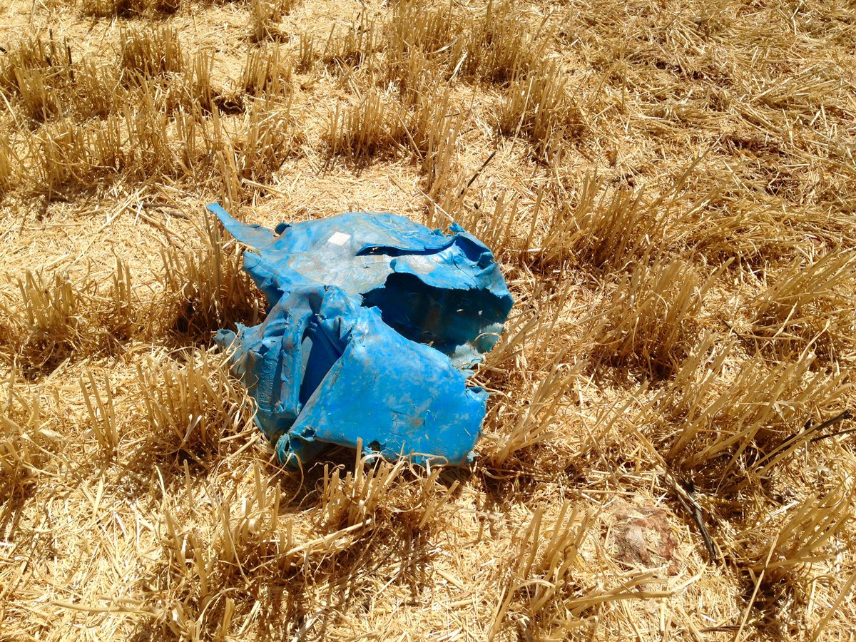 GribbleRC's tweet photo. ST rotors are renowned for their capacity to handle tough conditions.  But 20lt plastic drums ??? ........ just can't find a setting for them in the operators manual!  #straightthrough @CaseIHAus https://t.co/VbCKo49iyi