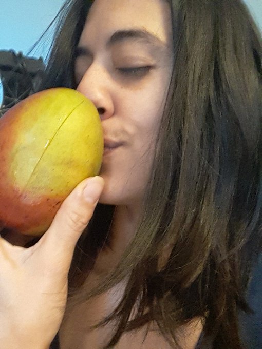 Good morning world eating a mango hanging out with my loves hope everyone enjoys their day https://t