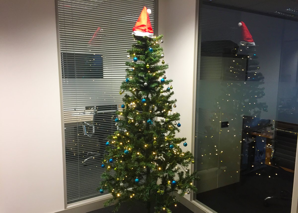 Main office Christmas tree now fully decorated with on brand colours too. Well done to the office elves 👏 (Not sure if the Santa hat tree topper is here to stay or not!). #office #Christmas2019 #decor