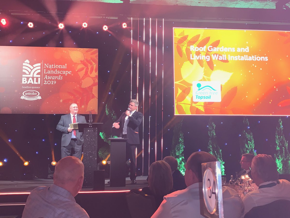 Greentechltd's tweet photo. Congratulations to @FrostsLandscape! We are delighted to be sponsoring this award, as you can see by our Business Development Directors Mark Wood's cheesy grin! @Greentreesoil #BALIAwards2019 https://t.co/zZWkYYqxlM