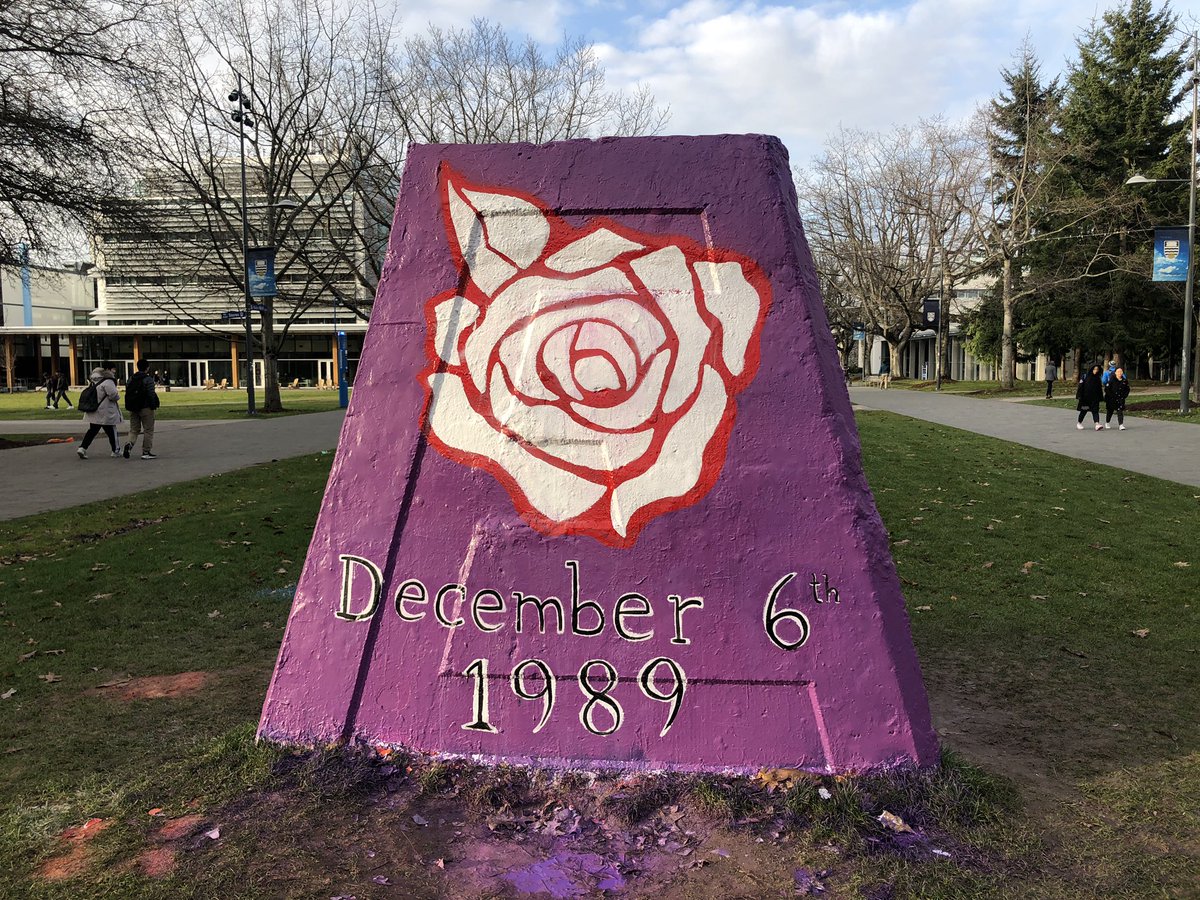 Purple cairn with a red and white rose, reading December 6, 1989