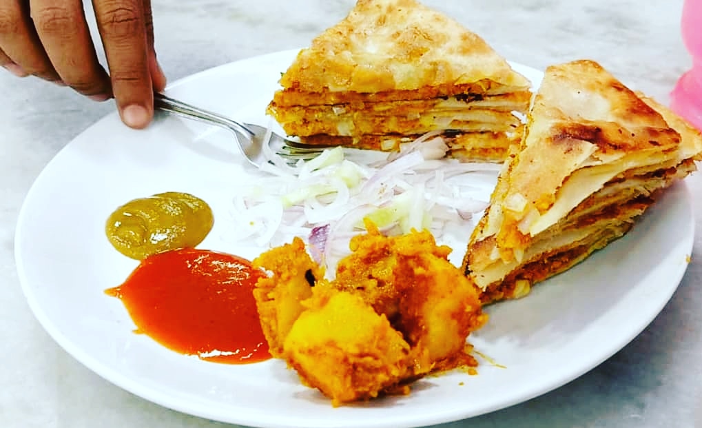 Delicious, hot and piping Bengali Mughlaiparatha / minced meat stuffed paratha

Mughlaiparatha is an exemplary  illustration of Mughal influence onthe cuisine of Bengal that had sneaked through thekitchens of Nawabs of Murshidabad and now has become street foodofKolkata.