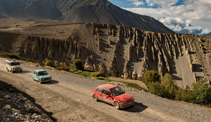 Three different vehicles race through the rock terrains of Mustang, Nepal.