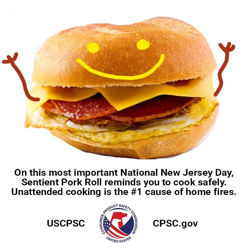 A picture of a pork roll egg and cheese with a smiley face. The text reads: on this most important National New Jersey Day sentient pork roll reminds you to cook safely!