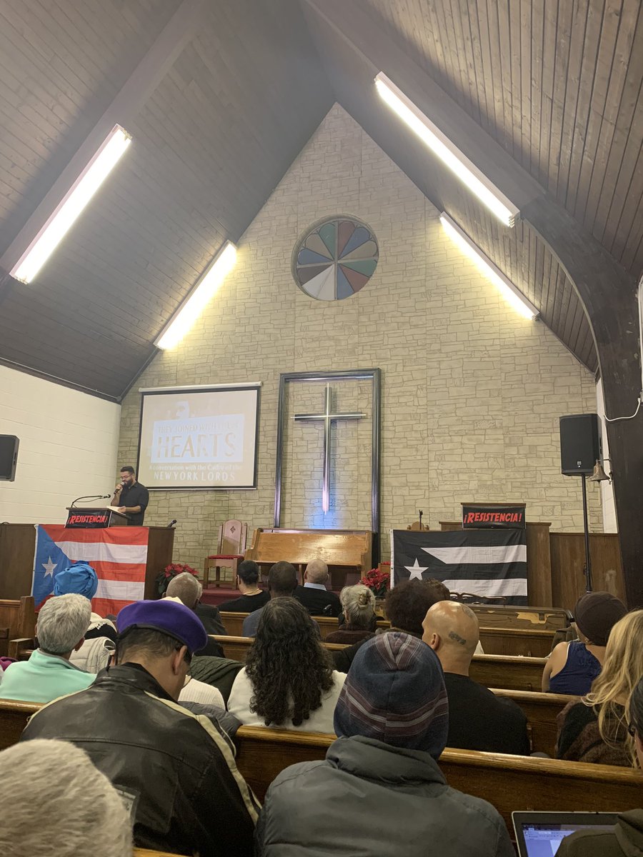 YoungLords50NY's tweet photo. Speedo Juan Pietri, son of Pedro Pietri, performs his father’s poem—“Puerto Rican Obituary”—in the same exact church his father performed it in, 50 years ago. 

#YoungLords50NY https://t.co/mRJRMcpaQP