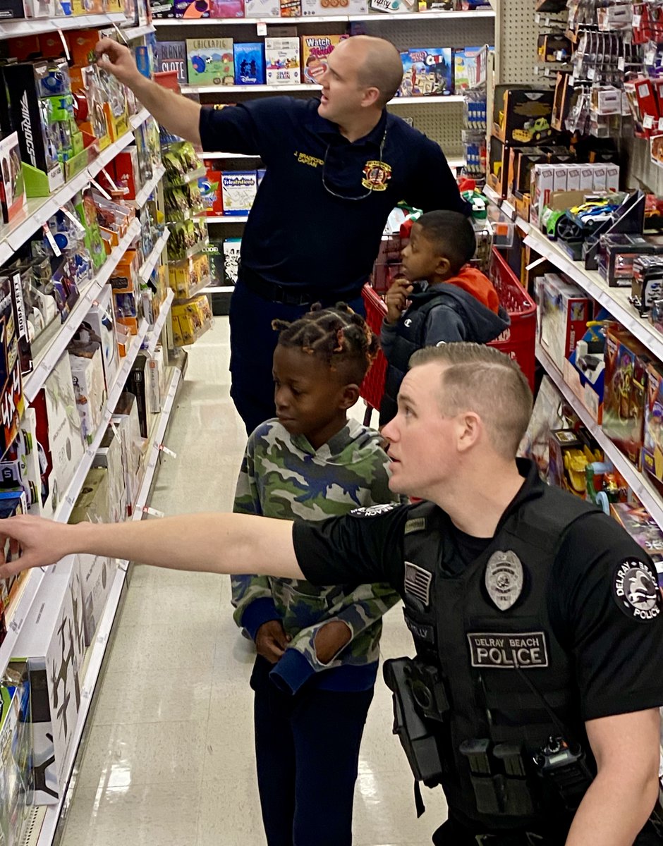 Delray Beach children got to shop with DBPD officers this morning during the 4th annual Heroes &amp; Helpers event. Children of all ages partnered with DBPD &amp; <a href="/DelrayBeachFire/">Delray Beach Fire Rescue</a> volunteers to go on a $100 holiday shopping spree at Target. #Tistheseason #TEAMDelray 🎄🎅