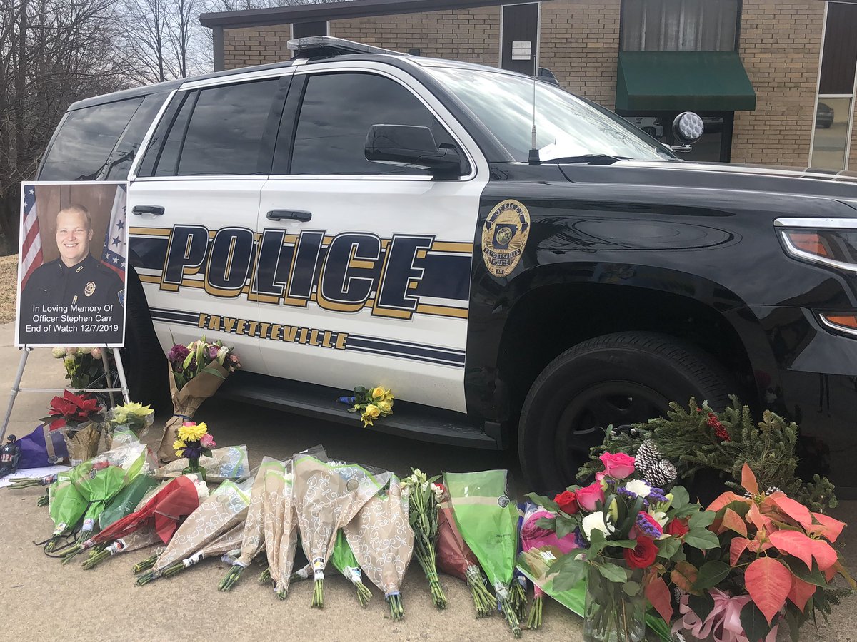 katelynngorton's tweet photo. A memorial has been set up for Stephen Carr outside of the Fayetteville Police Department.

While there, I saw people drop off flowers and hug officers.

My thoughts and prayers are with Carr’s family and the police department. https://t.co/vgvKny6YTM