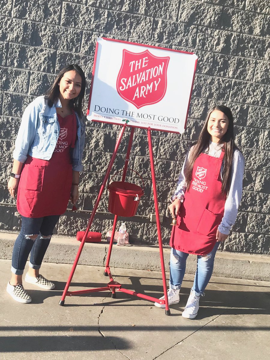NHS students Angelica Sanchez and Tania Molina help the Salvation Army by ringing the bell for donations.