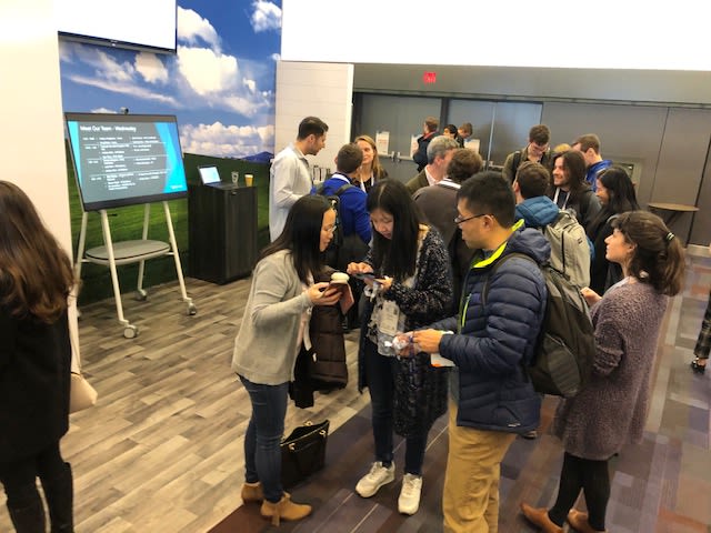 A group of people stand at the Microsoft booth at NeurIP 2019.