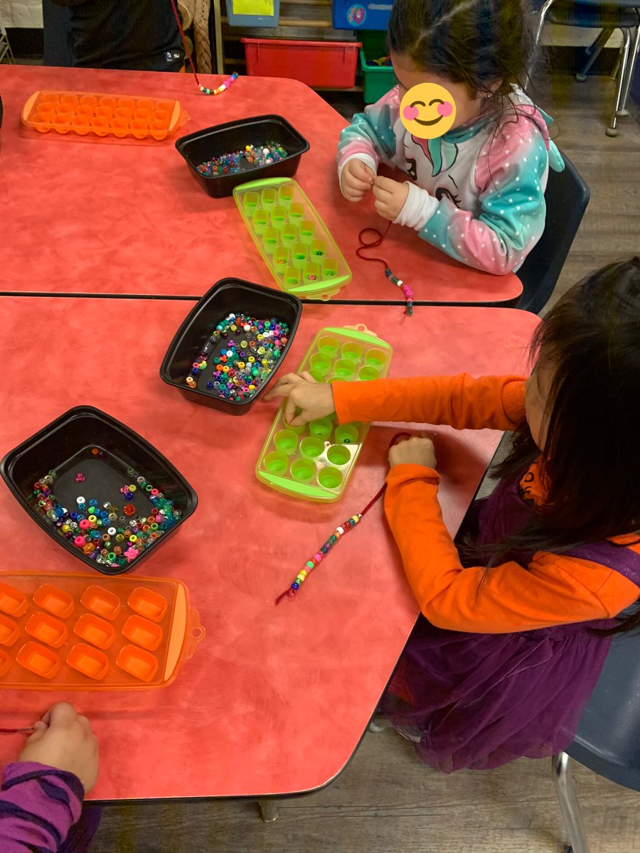 HannahRenaud2's tweet photo. Using beads and yarn during table tops today to make necklaces and bracelets! First we each counted out our beads in the icecube trays to practice counting past 20! https://t.co/rpiykxW6sX
