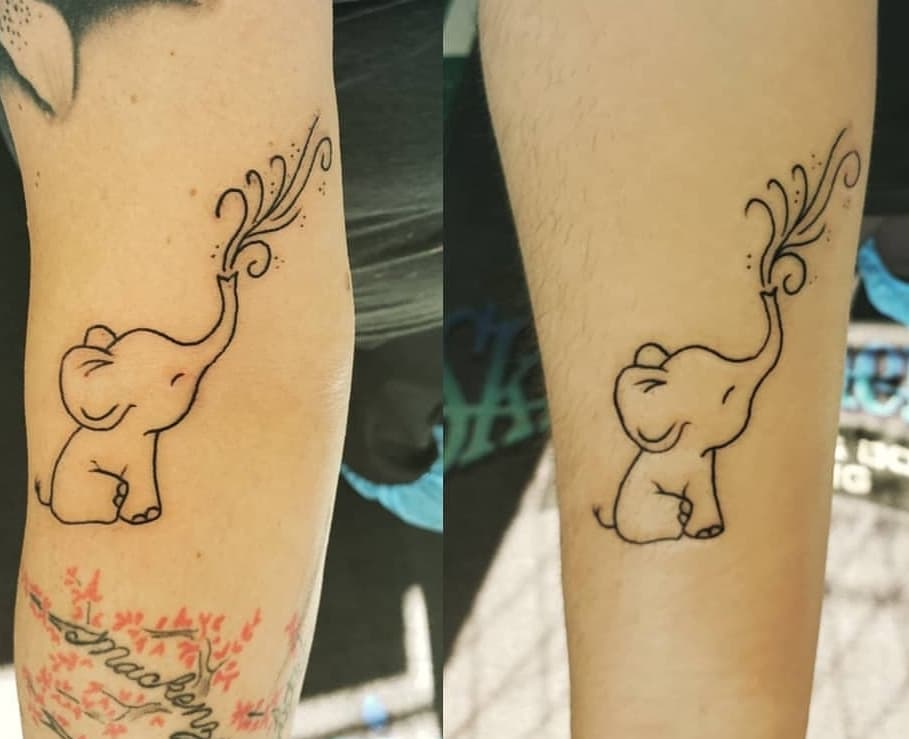 Mother and daughter matching elephant tattoo in fine
