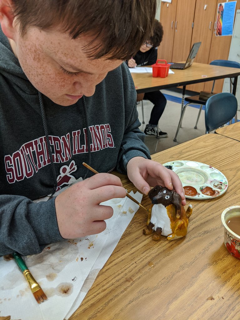 GJHSArt's tweet photo. "A boy and his dog",  Painting a sculpture of his dog. What focus! @GJHSPirates https://t.co/dmnlmhF5ry