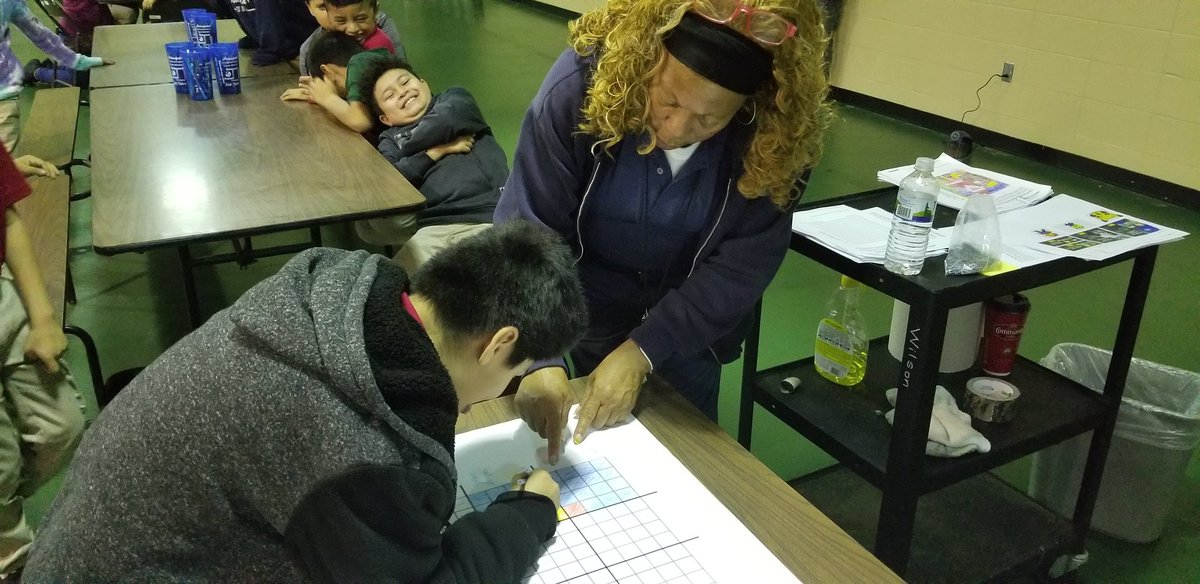 P.E. paraprofessional Coach Scott showing students how to do pixel art in physical education.  All hands on deck!!  Hour of code.  @WilsonAISD @AldineSTEM #ALDINEHoc