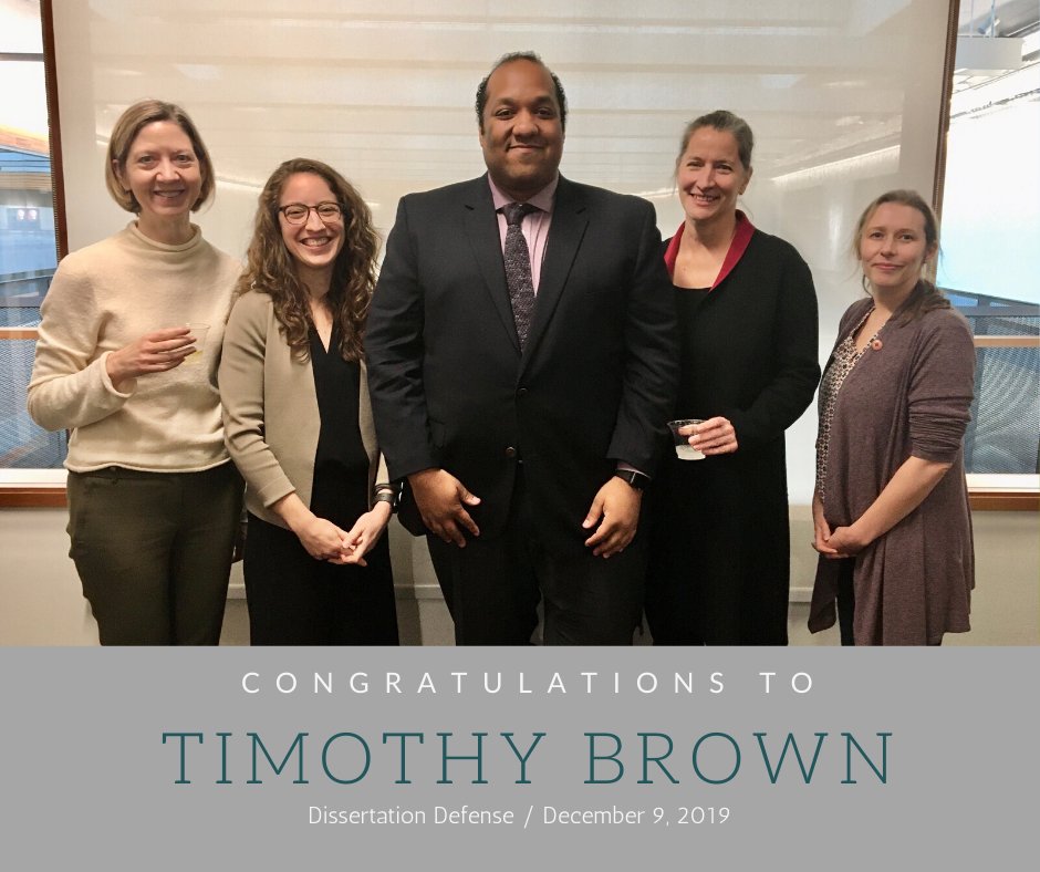 Tim Brown and his committee members smiling.