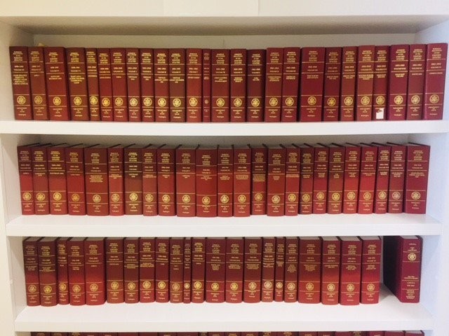 Three white shelves containing various FRUS volumes