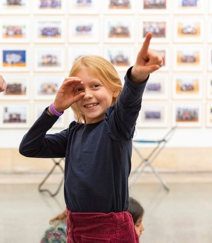 A child smiling and pointing 