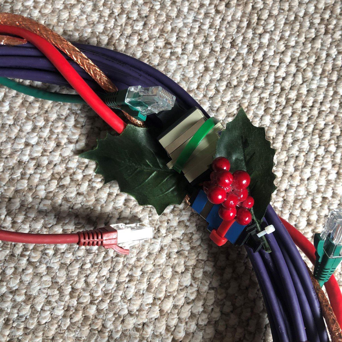 TVNET_ltd's tweet photo. Things are getting Christmassy!

We created this wreath using @ExcelNetworking Cat5e Cable, Coax, Patch Leads, Modules, Joiners and Bulkheads all fastened together with cable ties and finished with a couple Christmas decorations. It will be hanging proudly on our office door! https://t.co/E5EoafIvao