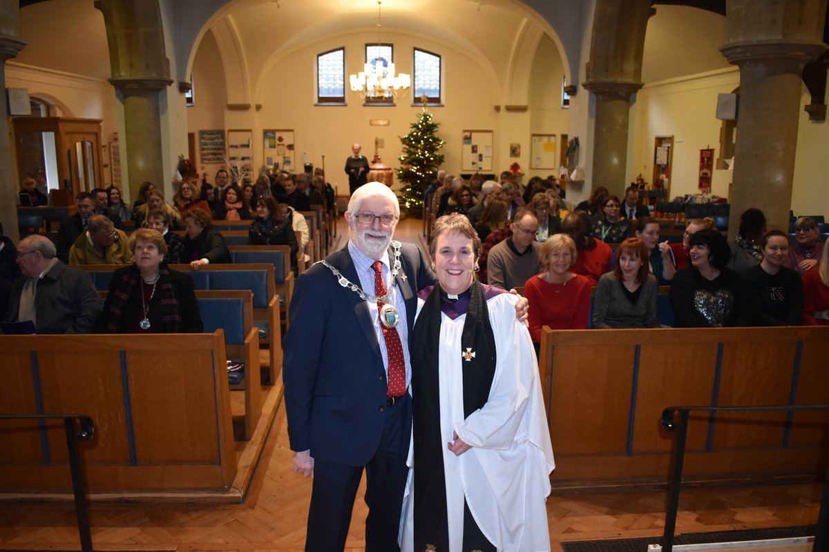 Chairman and Rev in a busy church smiling