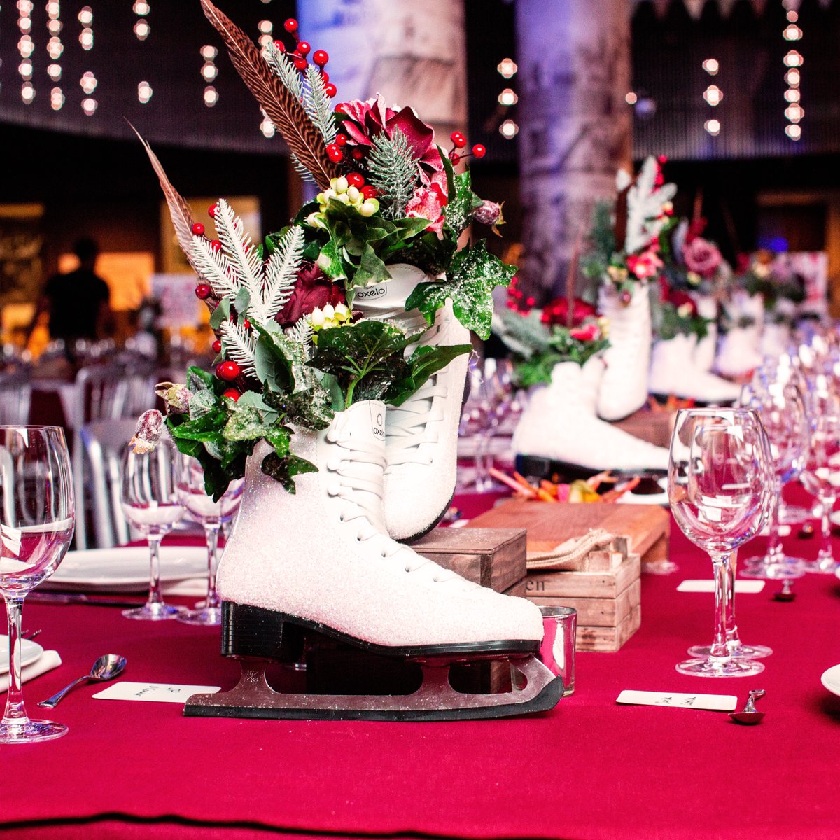 Week 1 of festive inspiration: Out of the ordinary Christmas table decorations! Adding holly &amp; berries shouts Christmas, but adding fake snow &amp; glitter onto a white ice skate is more memorable! These table centres feature at our Frost Fair themed parties at Museum of London!