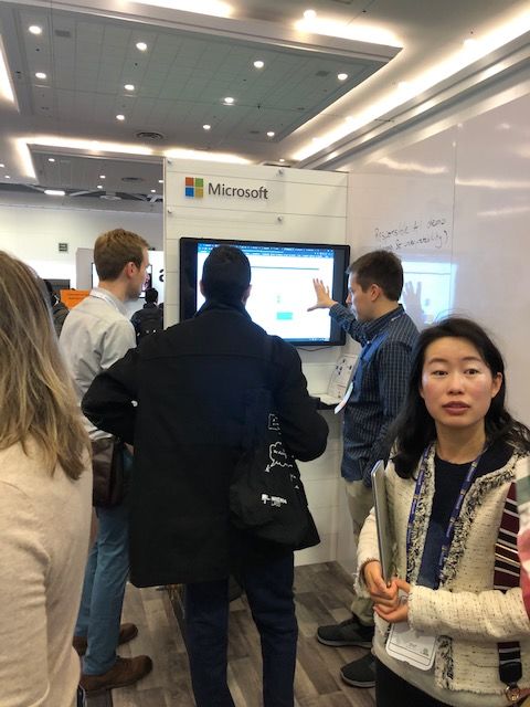 A crowd gathers around the Microsoft booth at Neurips 2019.