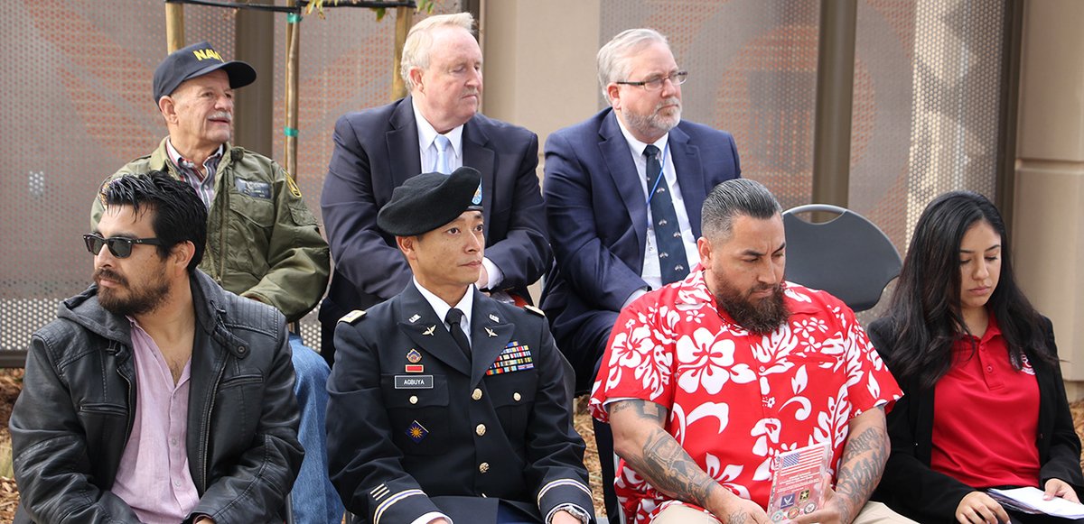 BAKcollege's tweet photo. Paul Beckworth, Faculty Lead for BC's Valenzuela Veterans Resource Center, introduced distinguished guests including trustees, legislators, city officials and students. The @goarmy Color Guard presented the colors. The Stars and Stripes wave proudly over Bakersfield College! https://t.co/PHVUEyEAe9