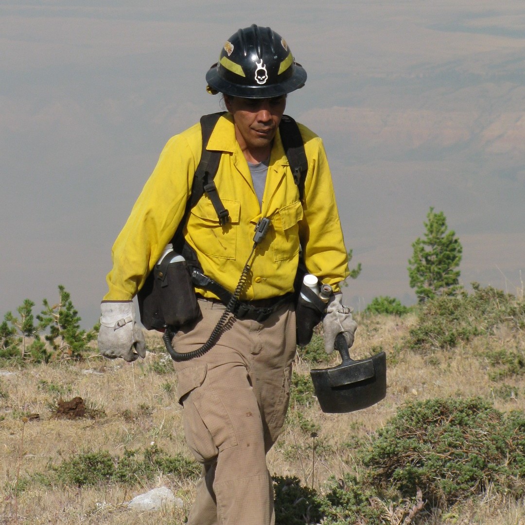 BIA Firefighter carries tool while on Aspen Grove Fire in AZ
