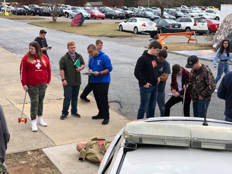 MaryFinley13's tweet photo. Students recently worked with the @NCSHP learning about traffic accident investigation and field sobriety testing. Great, hands-on learning experiences for @mcscte #Law and Justice classes. #CTEforNC #ctworks https://t.co/i8biIToZ0n