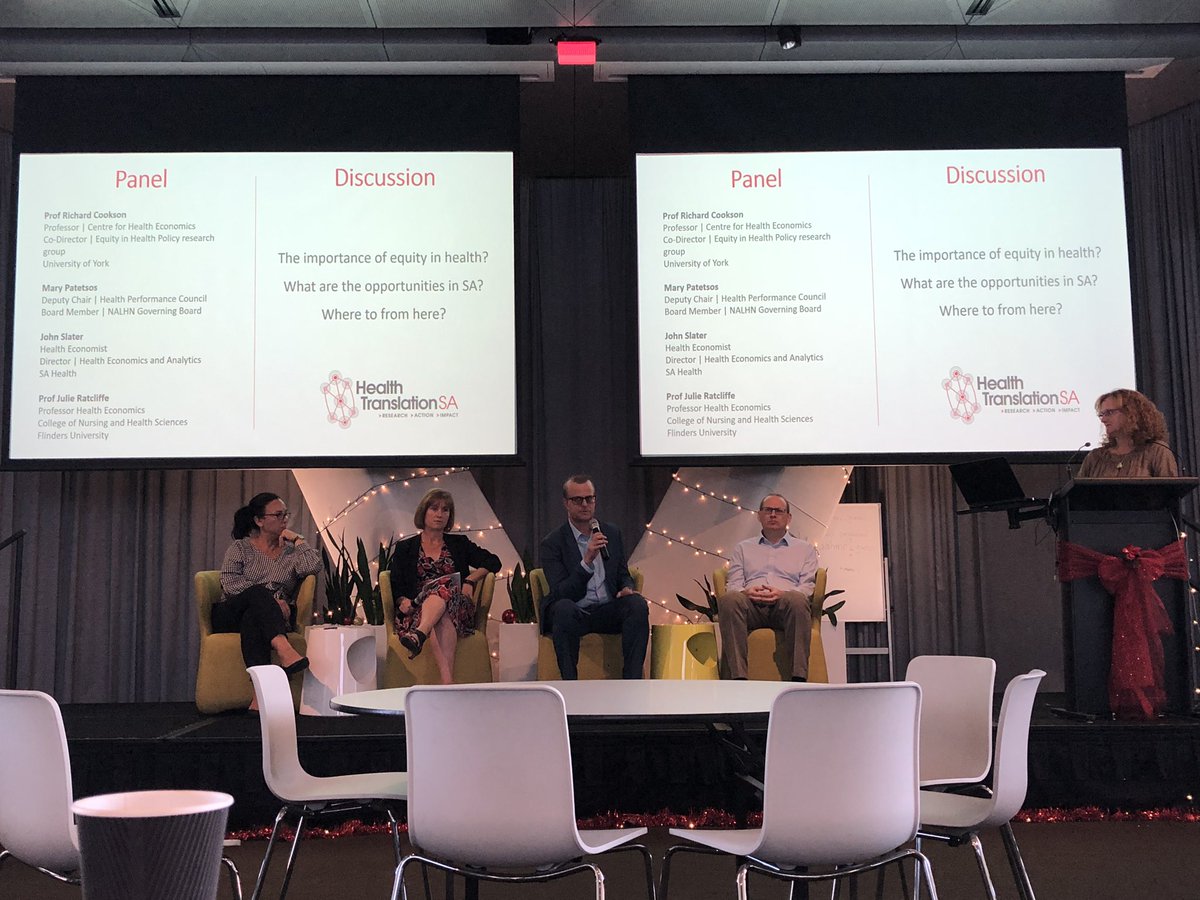 Group of four people sitting in front of projection on a screen