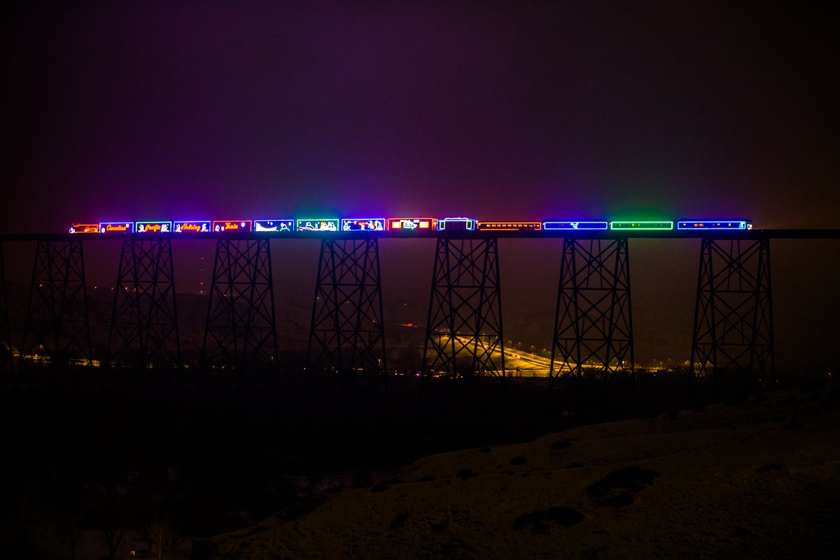 VisitLethbridge's tweet photo. The #CPHolidayTrain as it passes over the world's largest trestle bridge in #Lethbridge on December 10th, 2019. #YQL https://t.co/uIgM7ayK4d