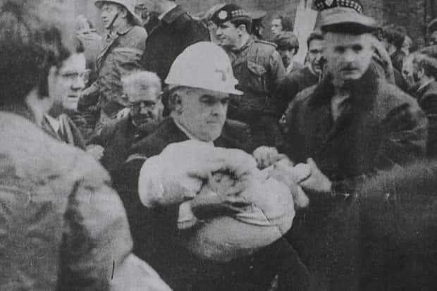 Alan Lewis (Northern Irish) Leading ambulance man Bob Scott removes the body of the youngest victim of the Shankill Road Bombing from the rubble, Belfast, 1971