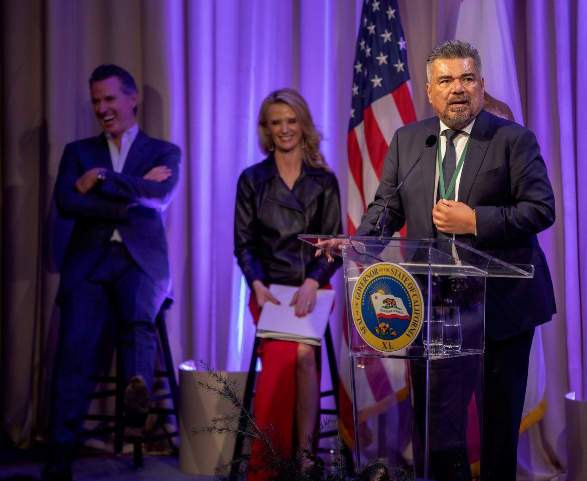 George Lopez, First Partner Jennifer Siebel Newsom, and Governor Gavin Newsom on stage at the California Hall of Fame