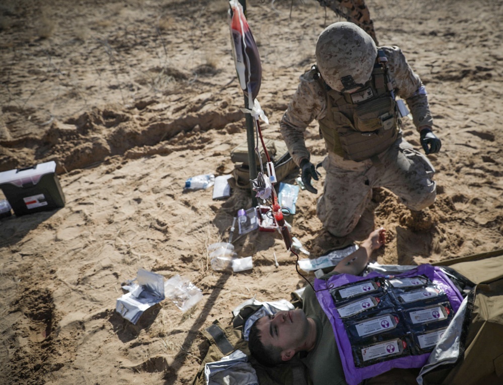 USPACOM's tweet photo. @USPacificFleet Navy Corpsman assigned to @1st_Marine_Div conducts a whole-blood transfusion practical application during #SteelKnight20 @CombatCenterPAO. #FMF #ReadyResilient #Exercise #FreeandOpenIndoPacific https://t.co/qRqV3gvqRr