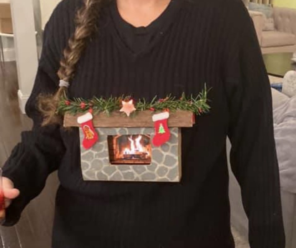 I won the DMA Ugly Sweater contest! Had the idea, googled to see if others had done it, discovered that my favorite youtuber 
<a href="/MarkRober/">Mark Rober</a> had this idea years ago, used his sweater as inspiration: mine=hand painted cardboard, phone playing fire video w/velcro, sewn w/ pipe cleaners
