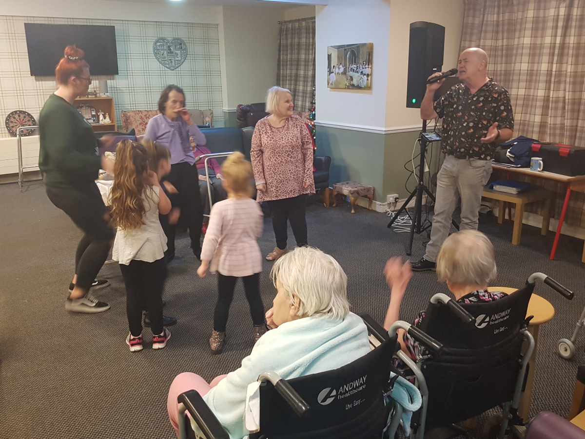 Carehomesuk's tweet photo. The Christmas party at Agnes and Arthur went off with a bang as Glyn Jones entertained residents and visitors 🎉🎄🎶👨‍🎤

#MeaningfulActivities #Xmas #DementiaCare #MusicTherapy https://t.co/LuymoqRQCf