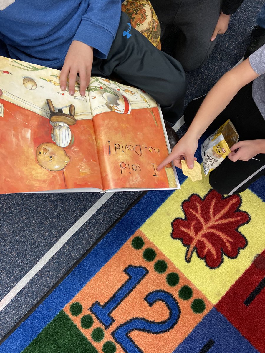 A proud reader shares his library book to his friends! (And the friends are joining in on the reading fun!)