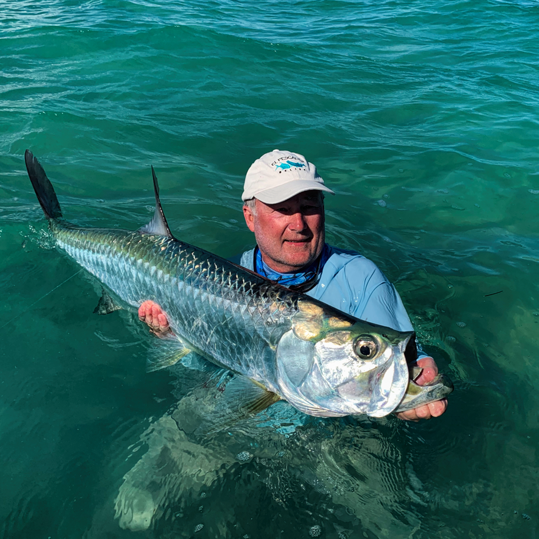 fishbelize's tweet photo. Dr. John, out fly fishing with Captain Gordy, landed this nice Tarpon yesterday using a white tarpon bunny fly.  Fish of the Week Photo! https://t.co/zcKAZUQrYR