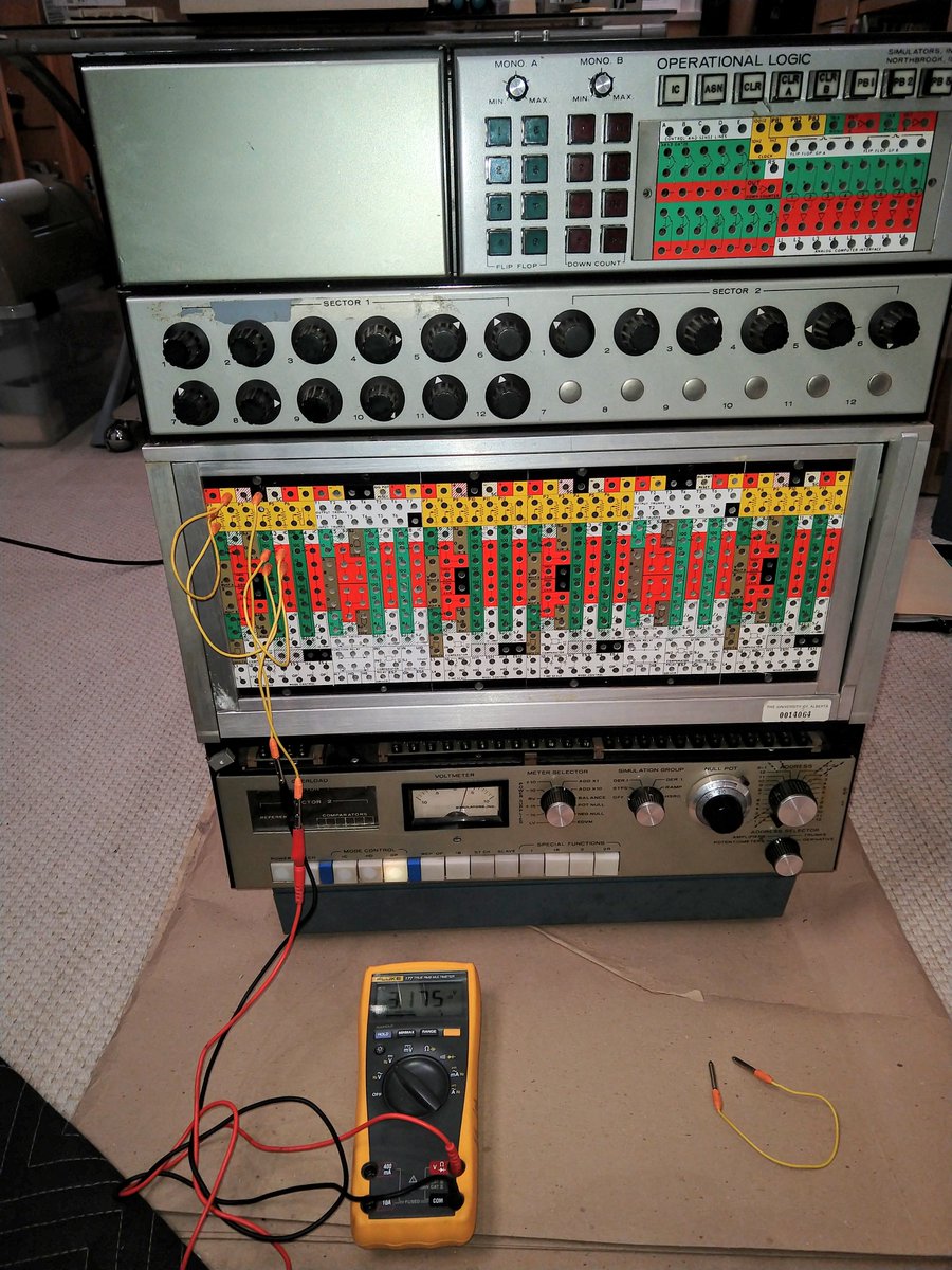 The analog computer is a mini-fridge sized box. It has a patch panel on the front for programming, as well as potentiometers and a meter.