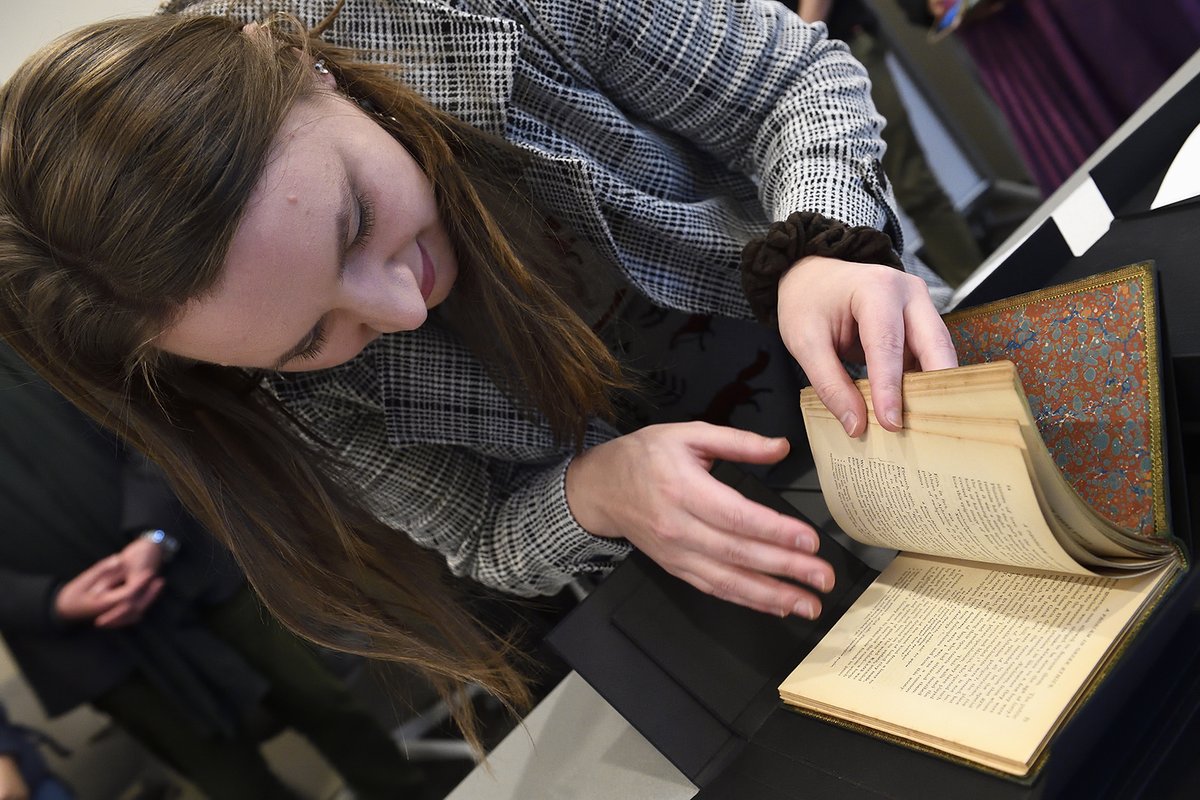 Johns Hopkins University student examines rare copy of "A Problem in Greek Ethics"