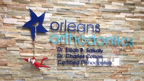 Orleans_Ortho's tweet photo. The countdown to #Christmas is on ... and #Charlie is getting pretty adventurous around the office, Mission Impossible-style antics from the Orleans Orthodontics sign! "Be careful, Charlie!" #ElfOnTheShelf https://t.co/qe43C8874B
