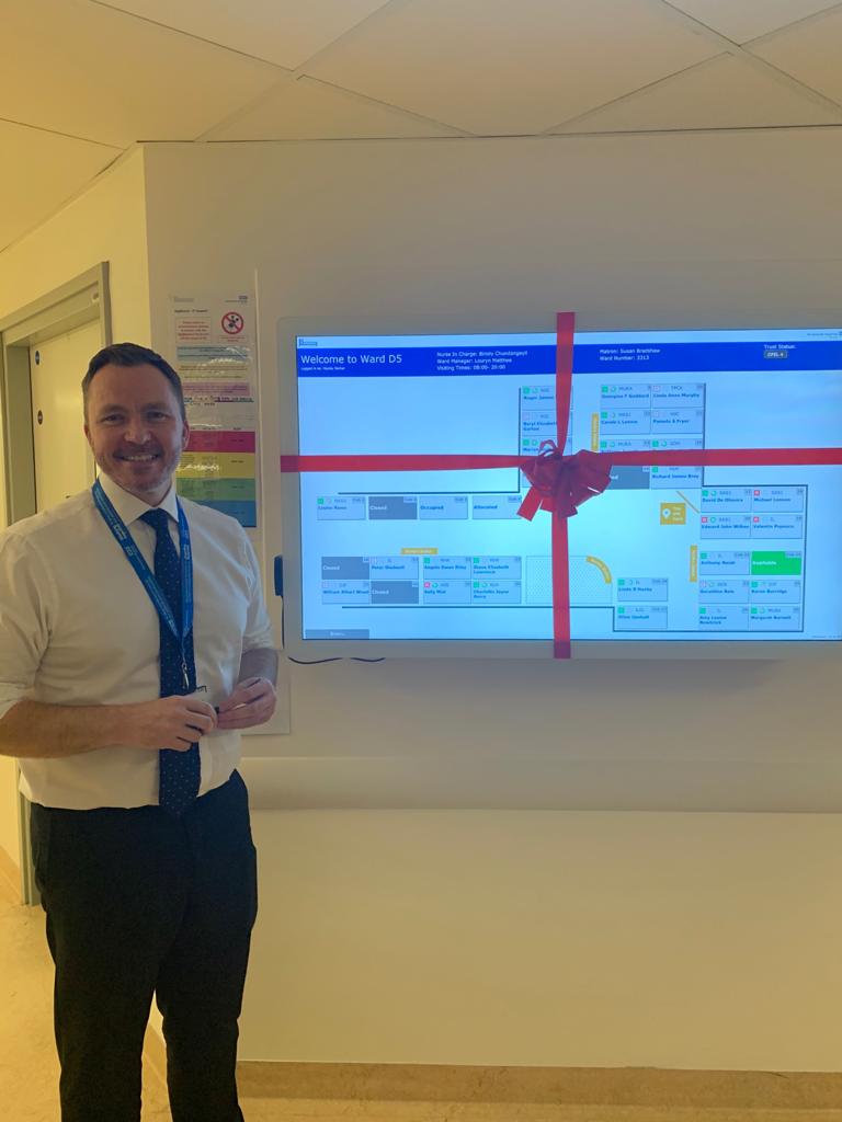 PHU_NHS's tweet photo. Ward D5 got an early Christmas present this week as their new digiboard was unveiled by Chief Executive, Mark Cubbon. Replacing the traditional whiteboards with electronic digiboards will support improvements in patient flow throughout the Trust. #ForPatients https://t.co/6FdIiBmQRe