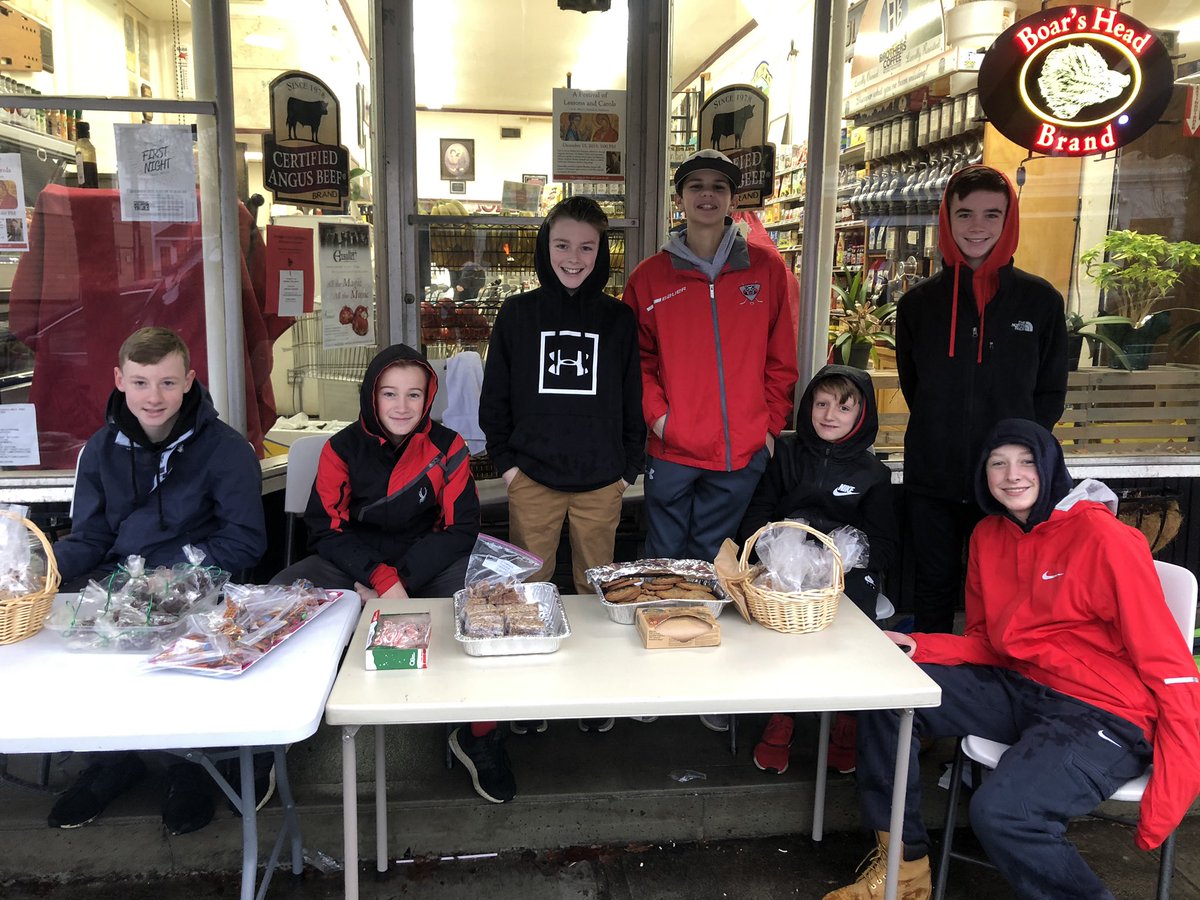 7th graders in pouring rain this morning in front of the Superette. Selling baked good to raise money for Project Just Because - please support them! #HollistonInnovates