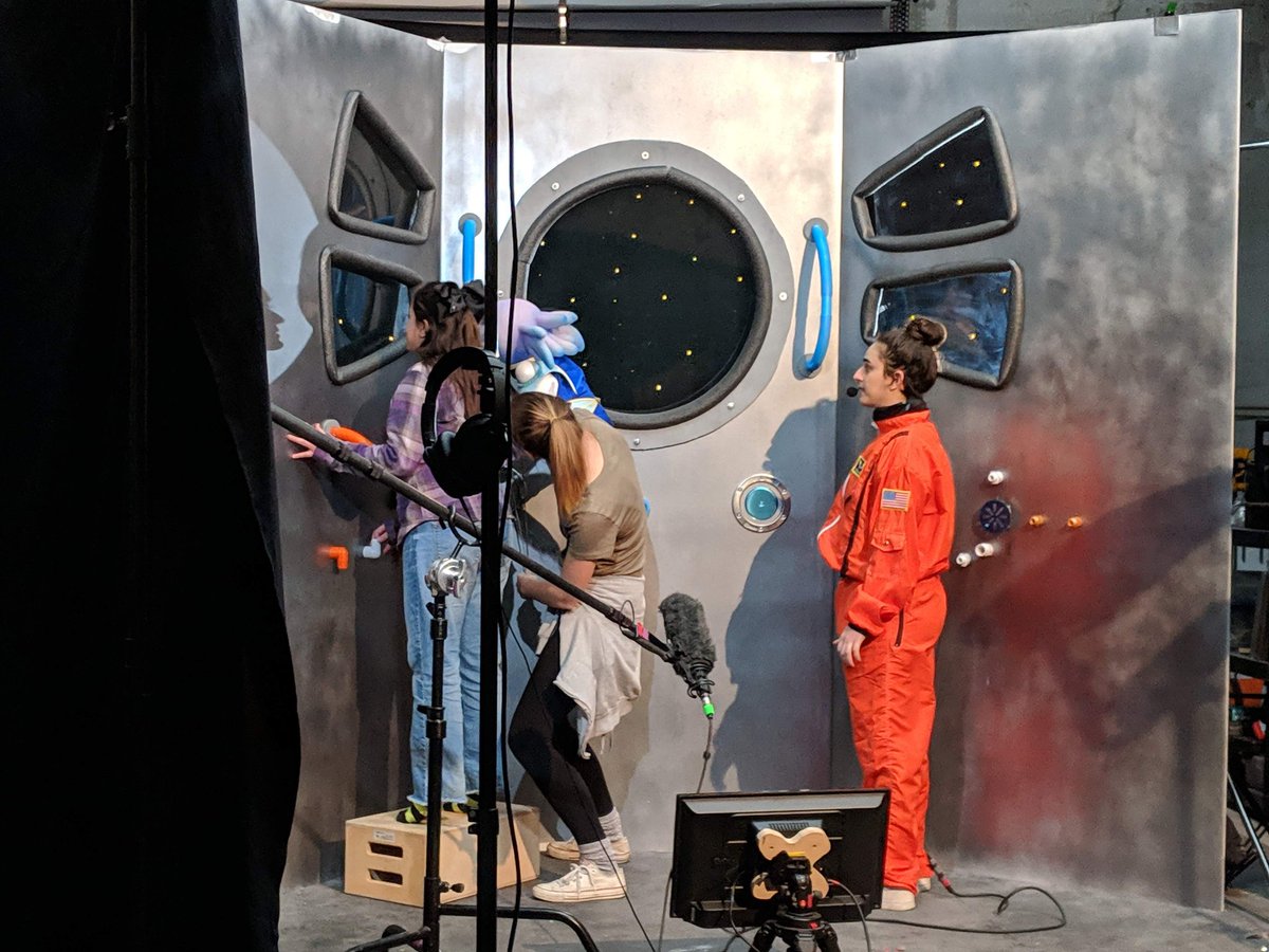 AdventuresOfEm's tweet photo. Revisiting one of our favorite sets: the space station! Using drywall, spray paint, and random plumbing trinkets from Home Depot, we were able to create the backdrop for not just Em and Susan, but eventually for Beep and Bop as well! https://t.co/kgzfTGsQm4