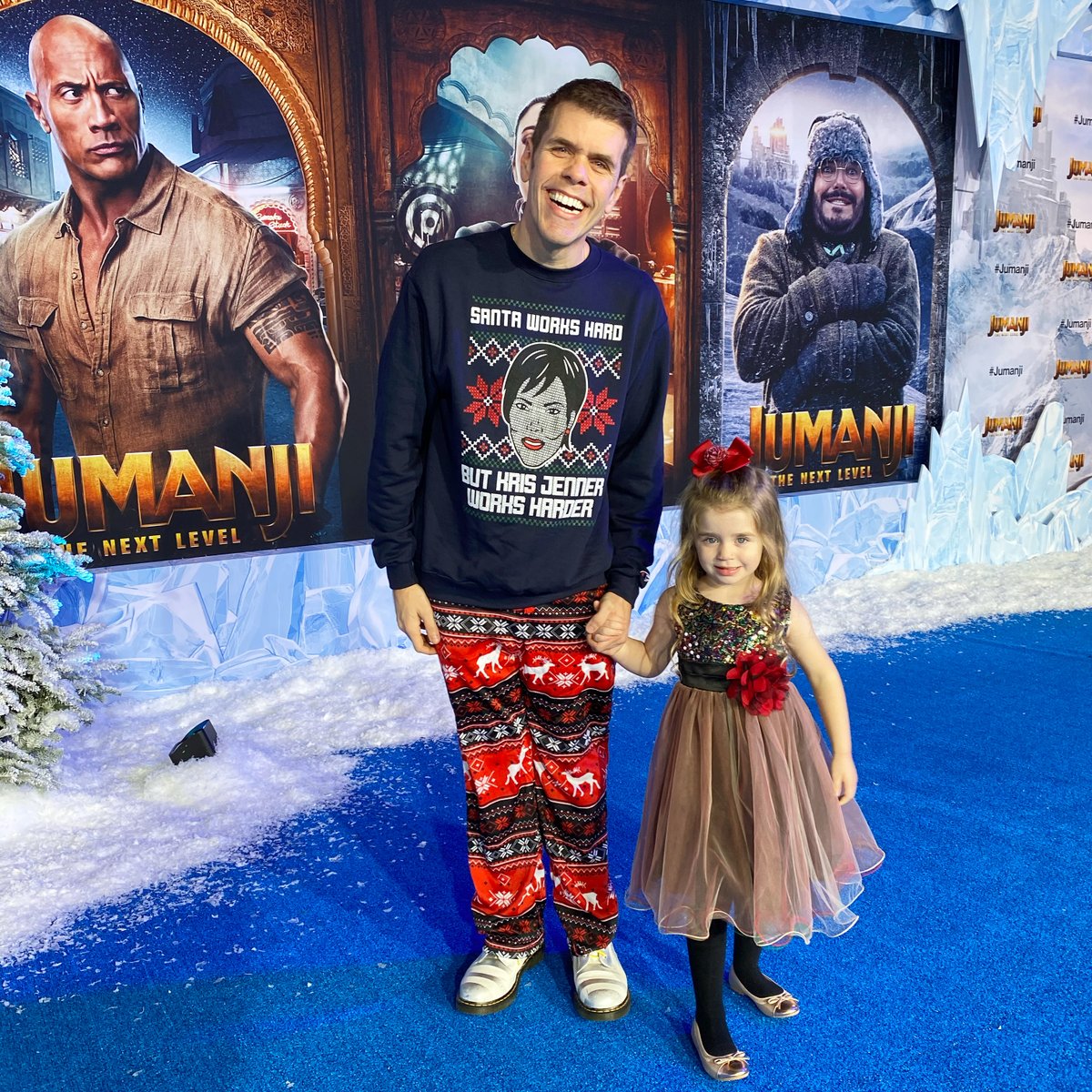 ThePerezHilton's tweet photo. We love fashion and we love being festive! At the @JumanjiMovie #NextLevel premiere with my angel! Mia's precious dress by @KidsDreamUS. My @KrisJenner Christmas sweater by @BarstoolSports. Thank you to @NicolaParish for inviting us! Watch our vlog HERE: https://t.co/XWBWnwQoTu https://t.co/qcx8r1TJw6