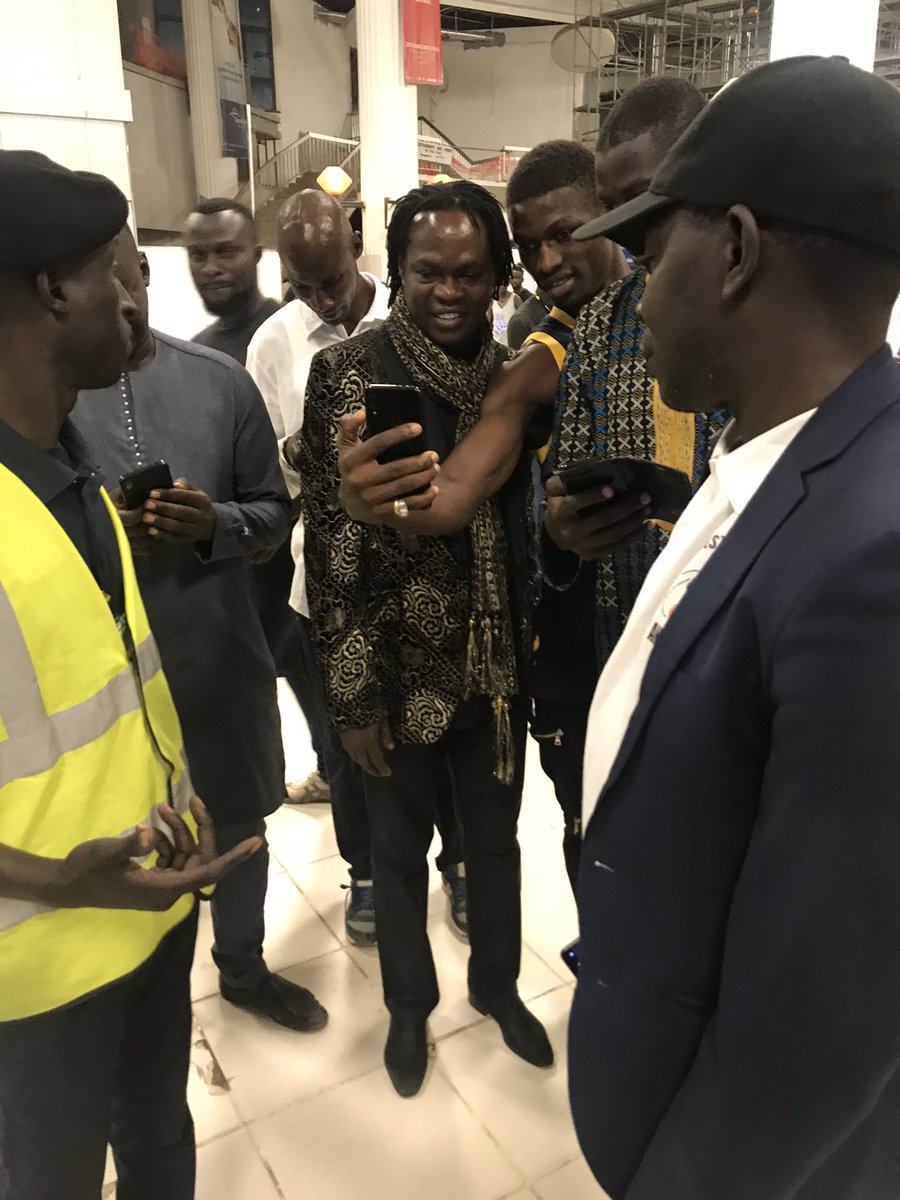 AfriCourage's tweet photo. 🚨 Baaba Maal’s arrival at #Banjul International Airport🛬. He received a warm welcome from the Fula cummunity in #TheGambia 🤗 #AfricourageIsHere #OpenMicFest #PowerOfTraditions #TheBigEvent https://t.co/QBexFgWnL6