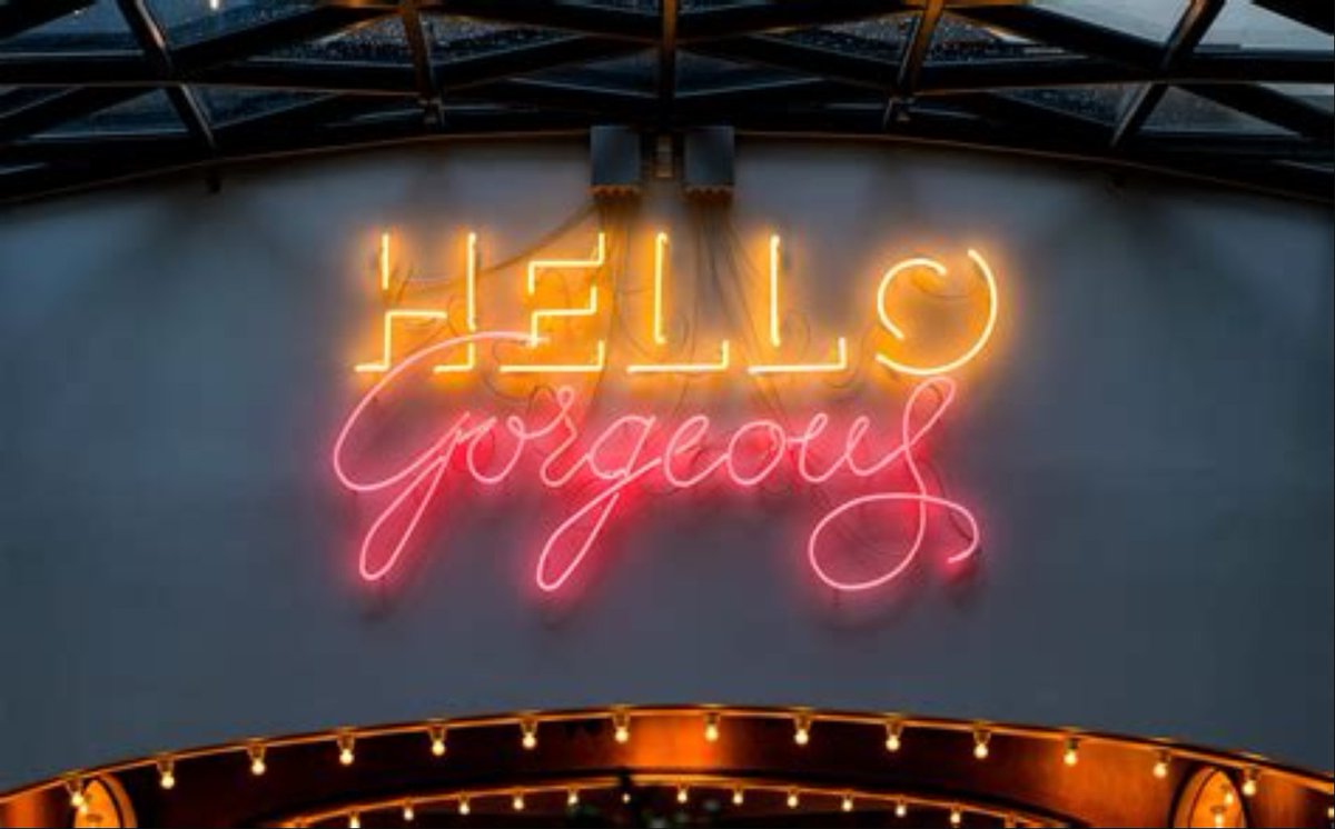 "HELLO, gorgeous" neon sign.
