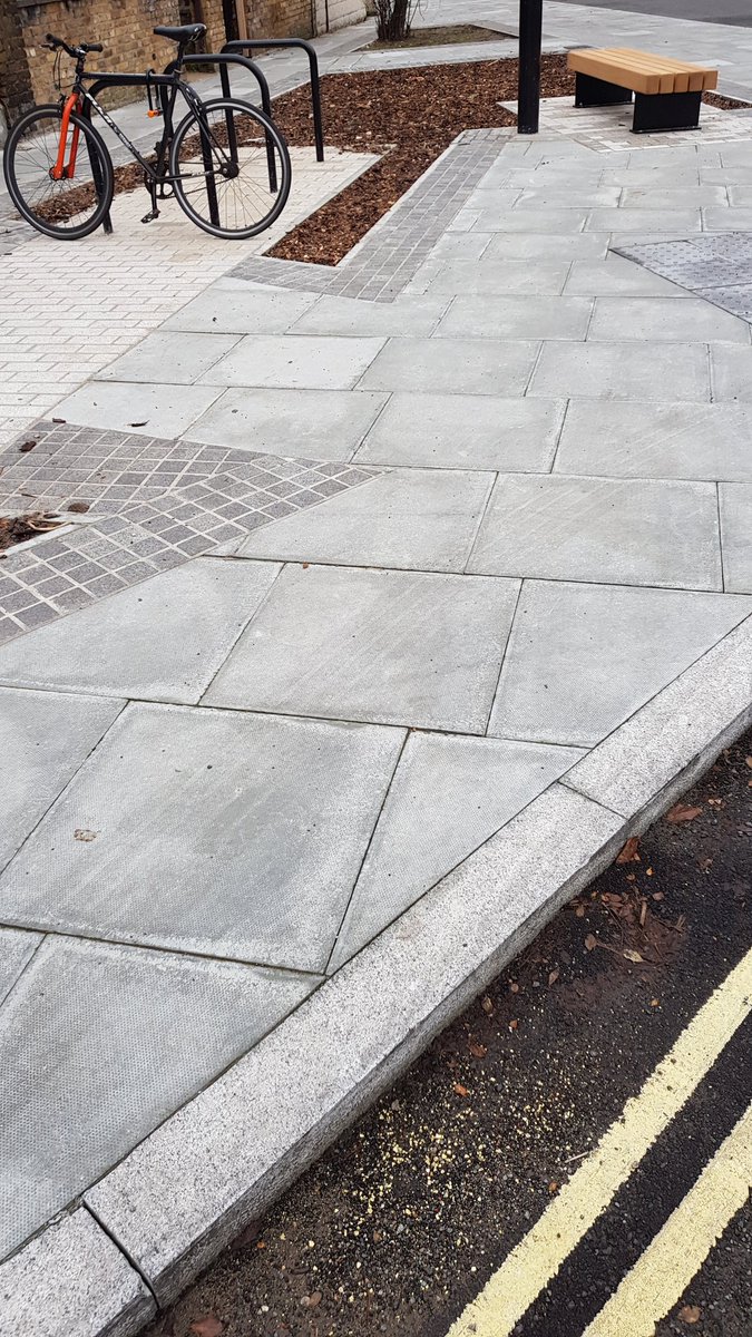 London's still getting it wrong. This kerb should have a channel to let rain flow into the little garden.
Too much concrete. 
Every new space like this could be greener &amp; help cut flood risk, reduce air pollution &amp; filter out toxins that damage rivers. 
It'd look beautiful too!